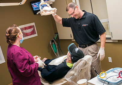Dr. Brian Blanchard working with a patient