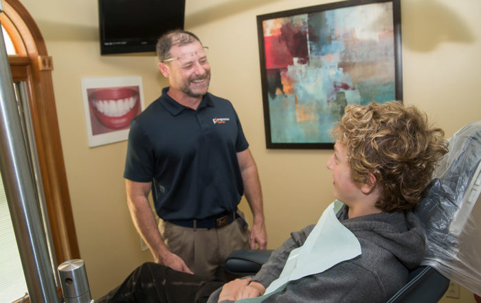Dr. Blanchard smiling talking with a patient