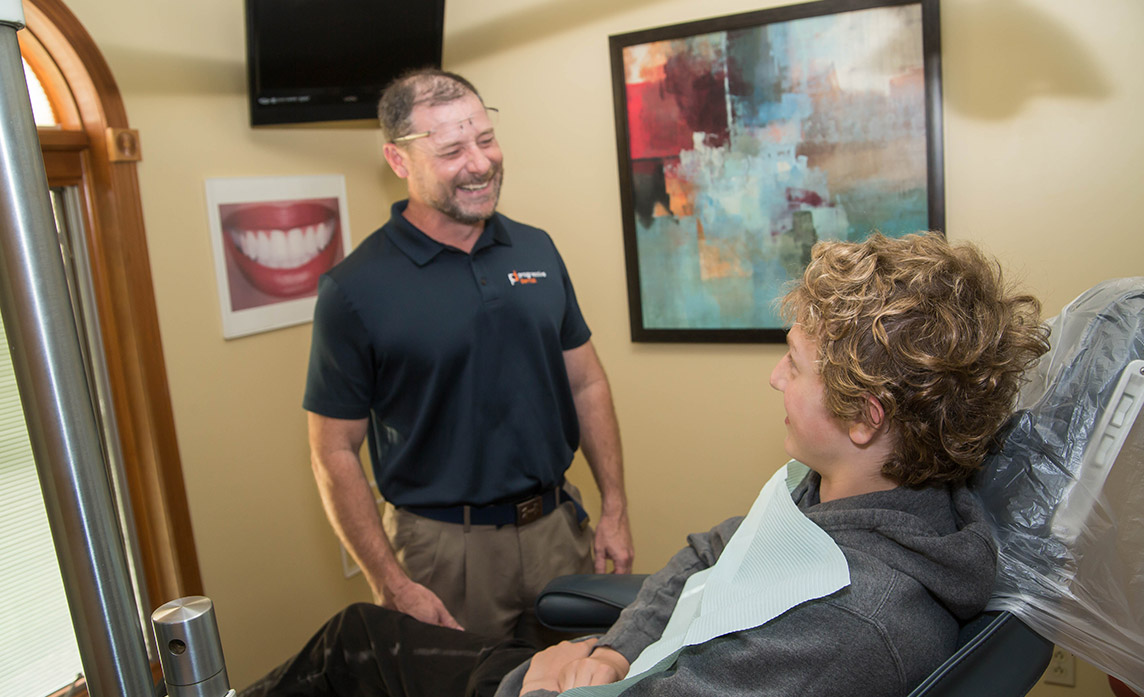 Dr. Blanchard smiling talking with a patient