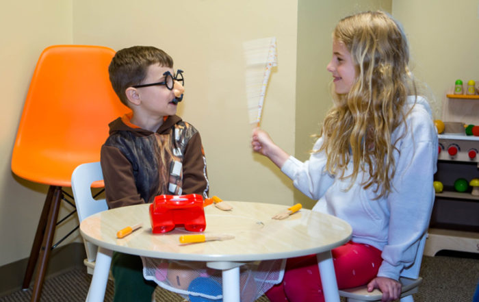 Two children playing in the Progressive Dental waiting room