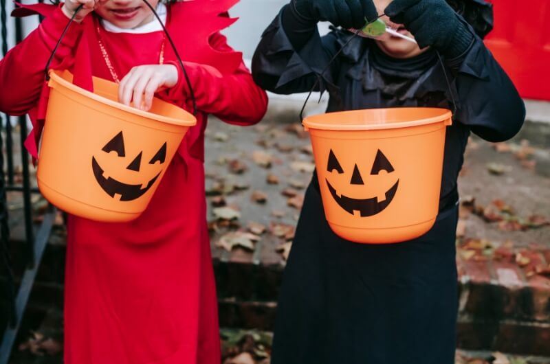 children holding halloween buckets